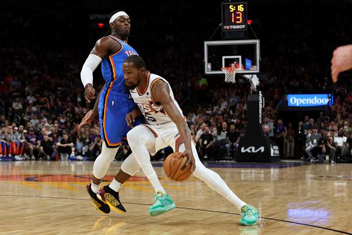 Nov 12, 2023; Phoenix, Arizona, USA; Phoenix Suns forward Kevin Durant (35) drives to the net against Oklahoma City Thunder guard Luguentz Dort (5) during the first quarter at Footprint Center.